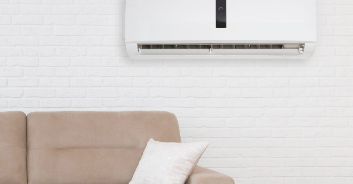 Air conditioner with temperature display above sofa in living room