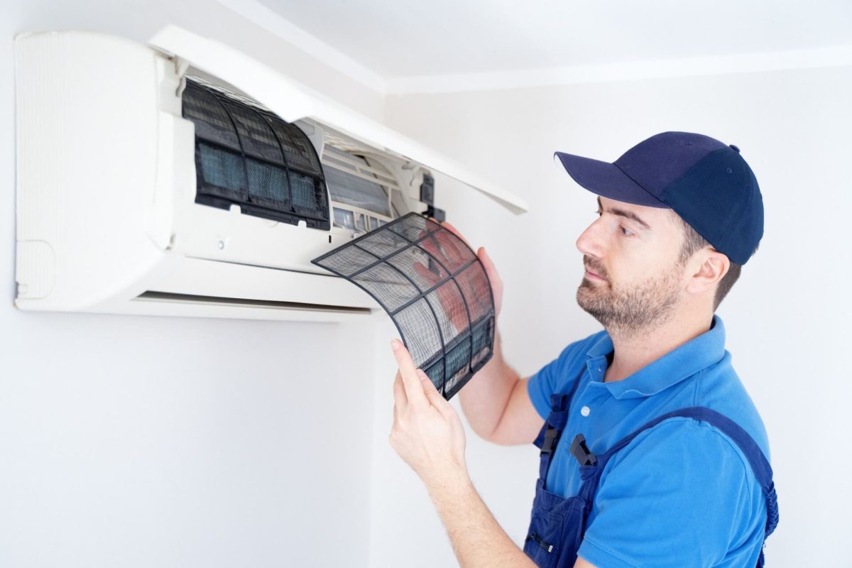 Close-up of technician inspecting a removable air filter.