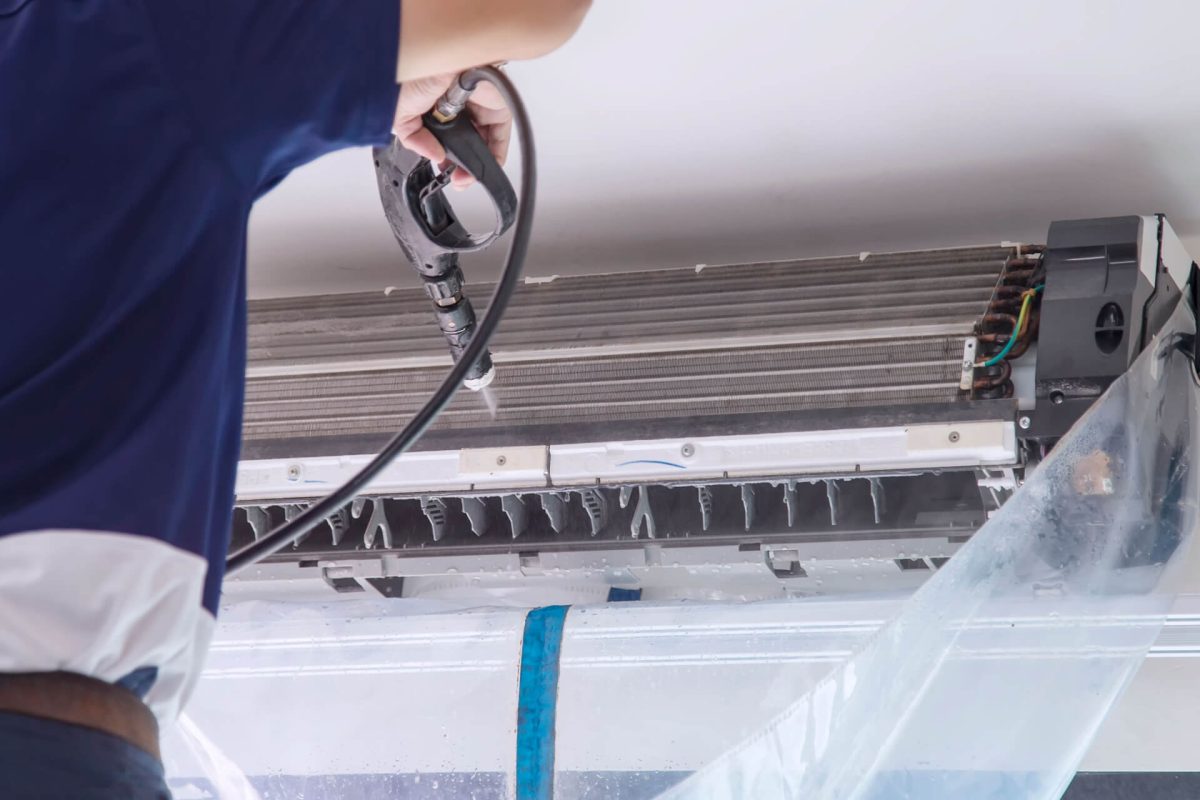 Close-up of air conditioner coils being cleaned during maintenance.