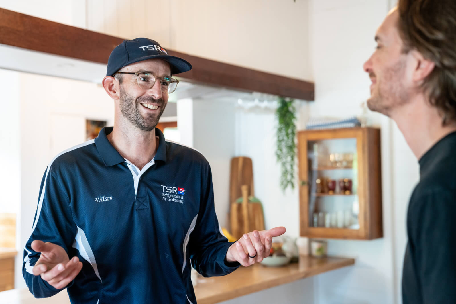 TSR team member speaking to customer inside home.