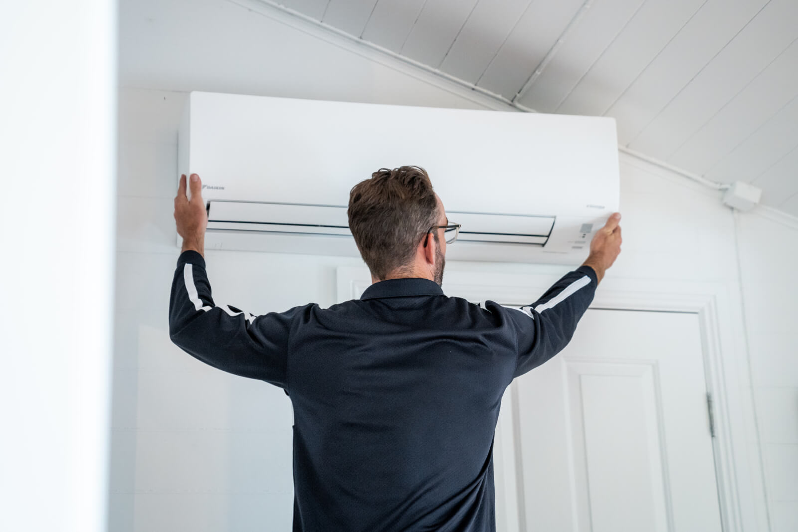 Installer mounting indoor air conditioning bracket.